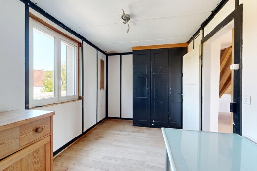 zimmer / schlafzimmer mit wood finish floor, holzfußboden, bauernhaustür, light floor, und manufactured ceiling panel
