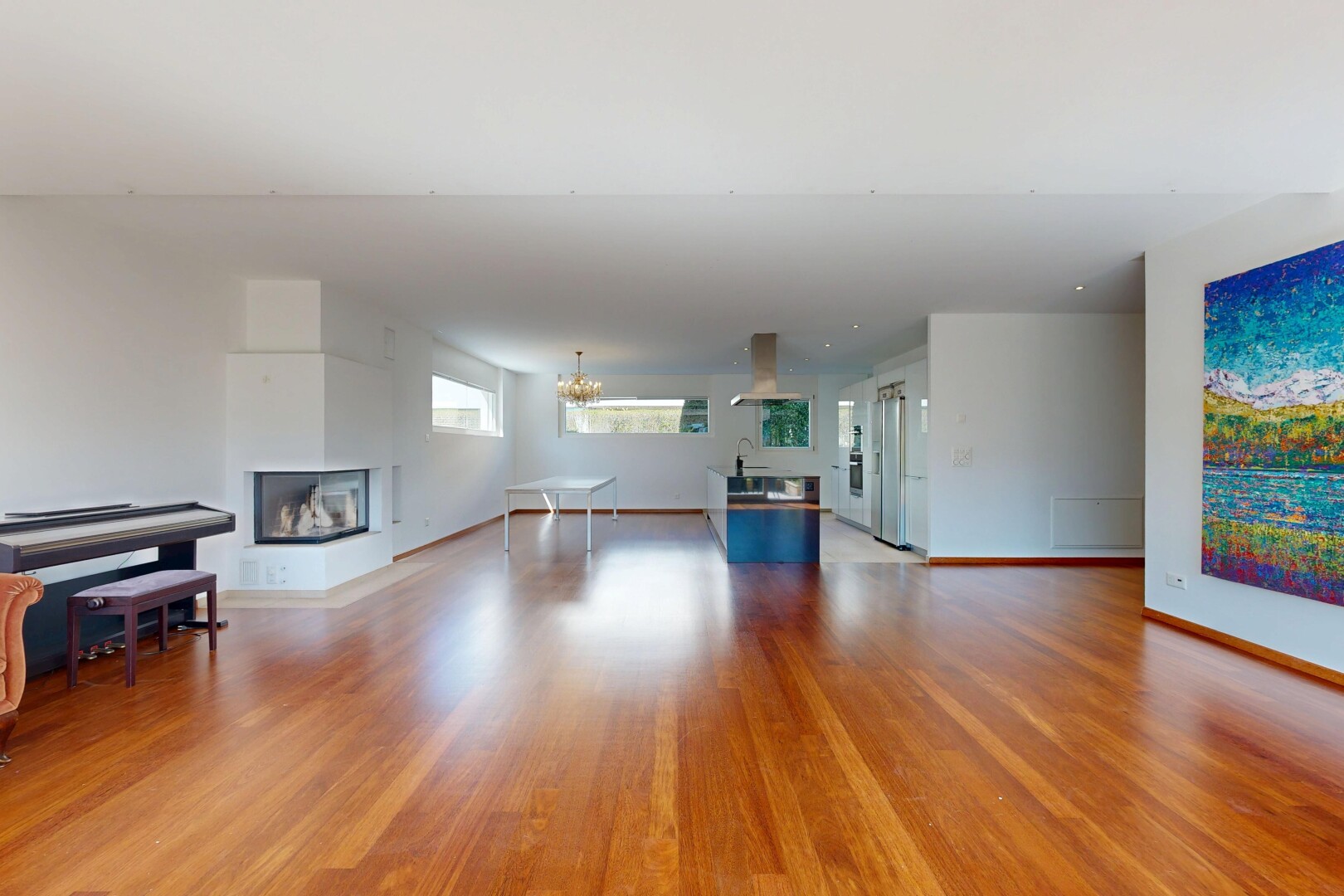 unfurnished living room with light wood-style flooring and a multi sided fireplace