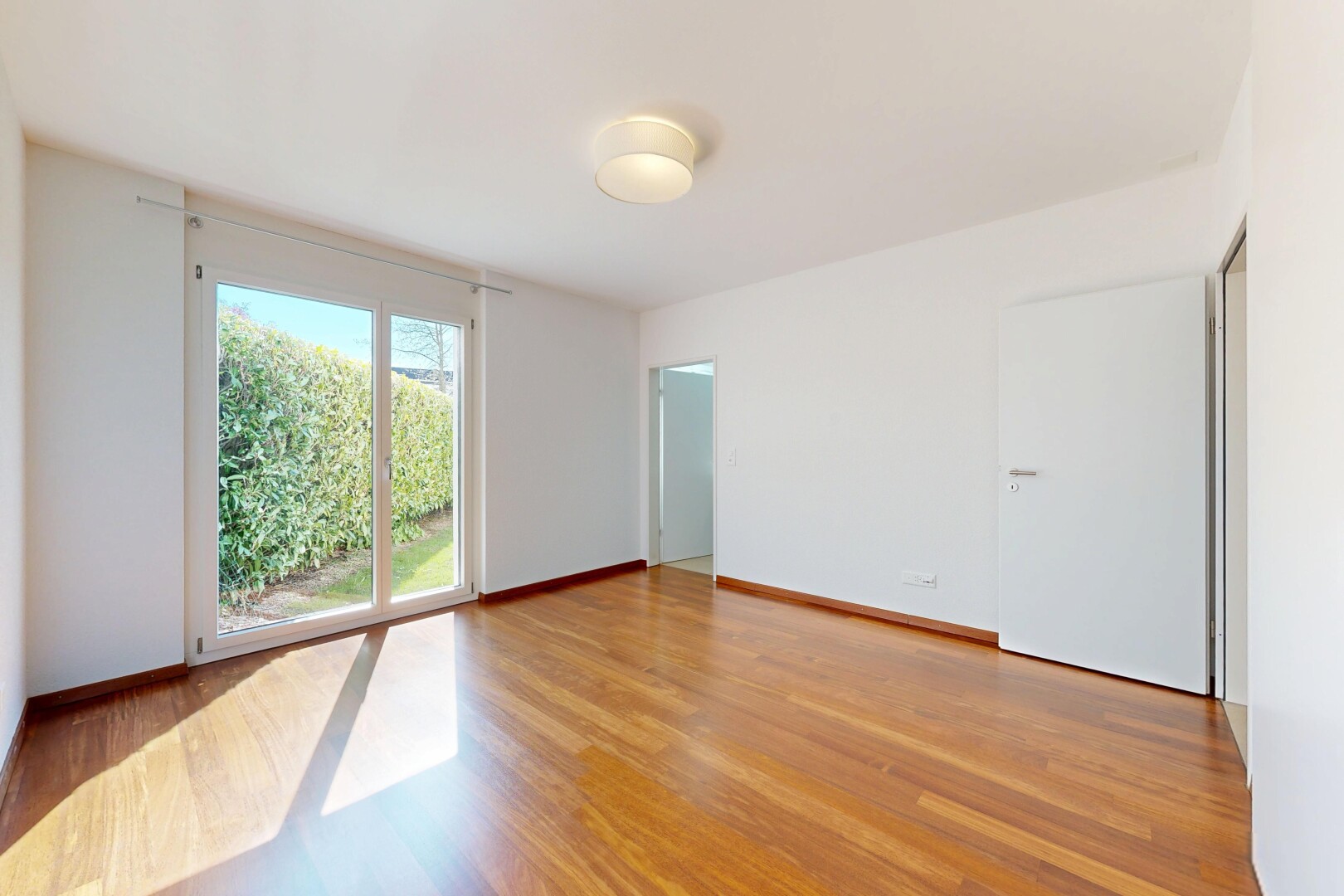 empty room with light wood-style floors and baseboards