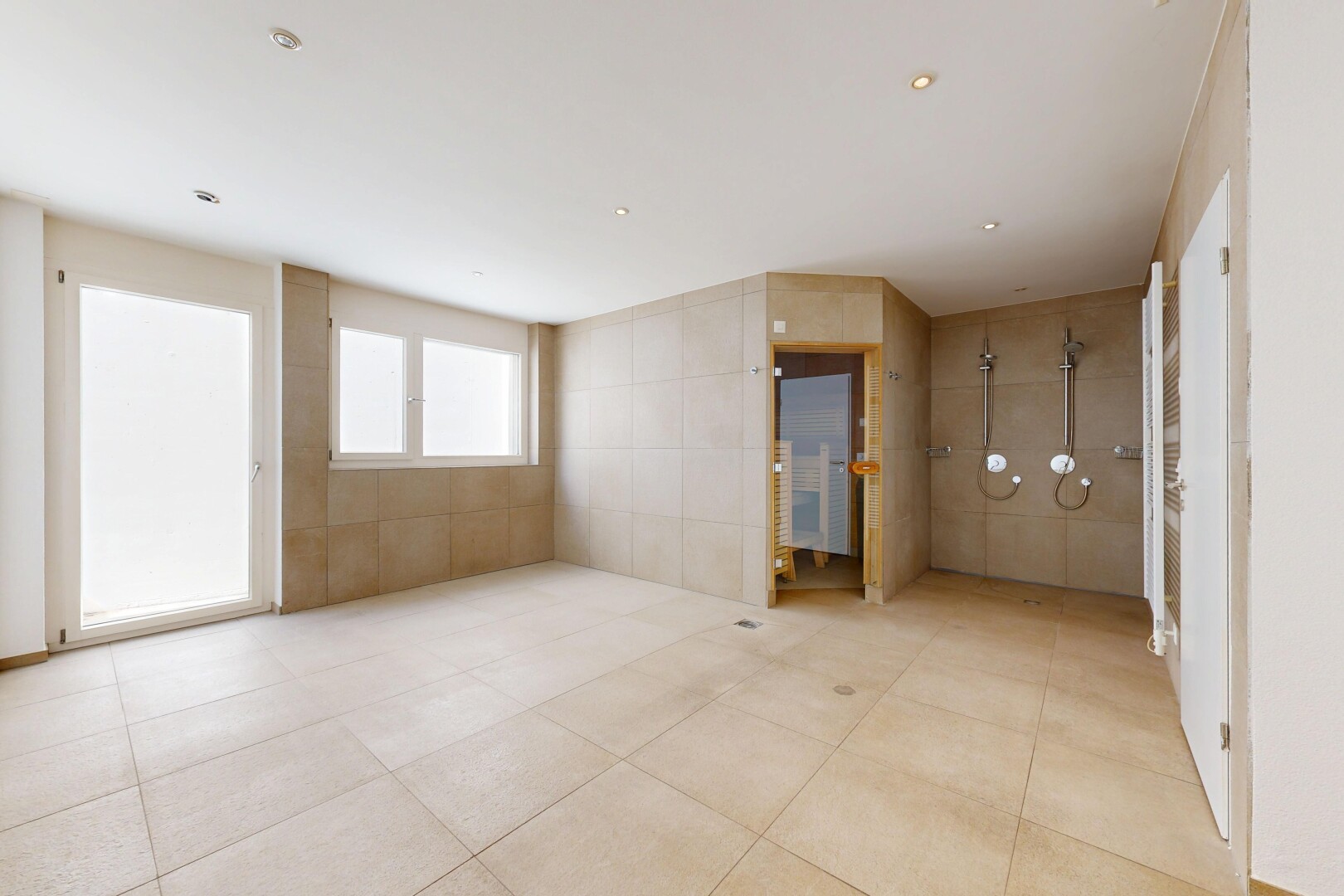 spare room with tile walls