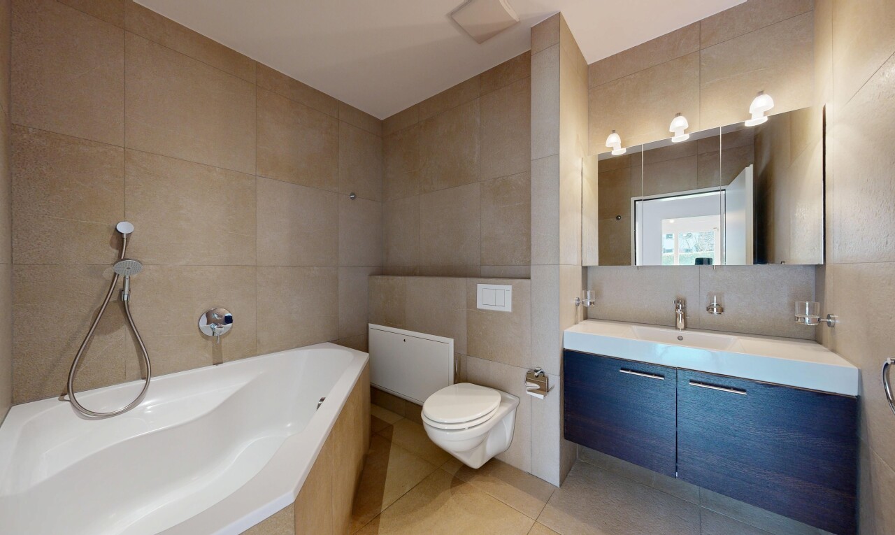 bathroom featuring tile walls, a garden tub, vanity, and light tile patterned floors