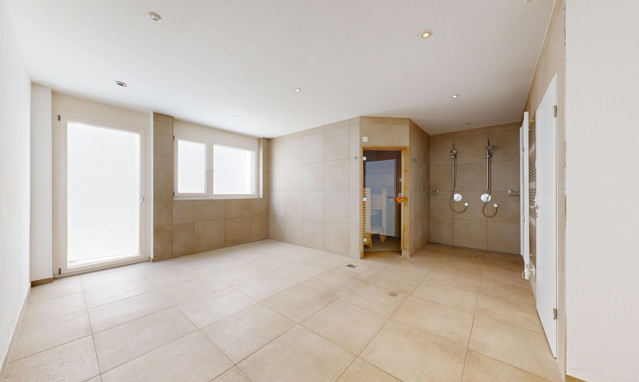 spare room with tile walls