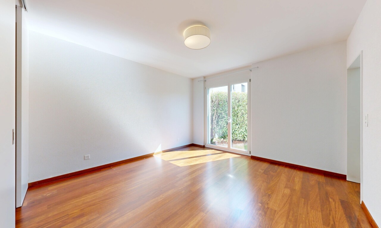 empty room featuring light wood-type flooring and baseboards