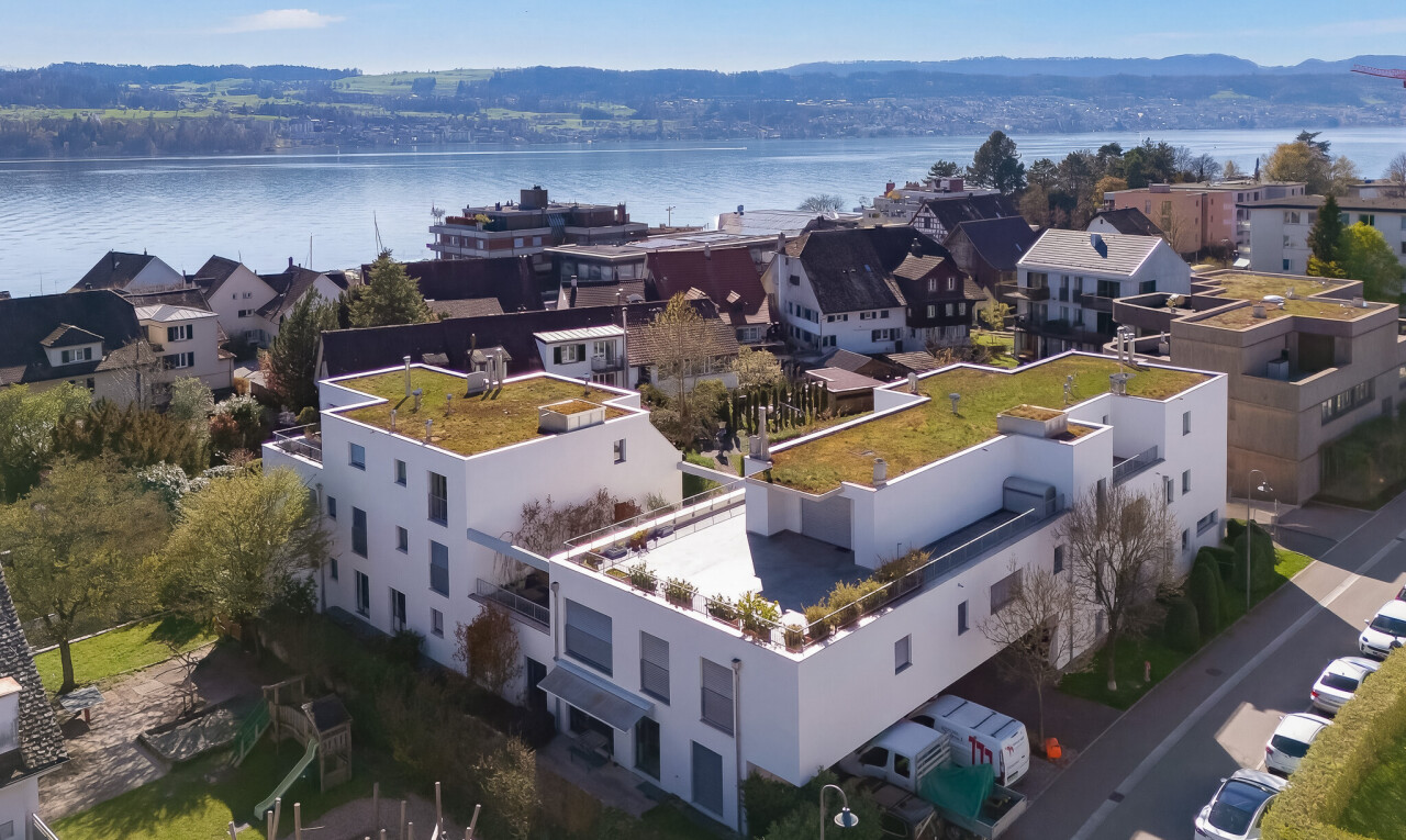 view of building exterior with a water view and a residential view