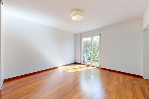 empty room featuring light wood-type flooring and baseboards
