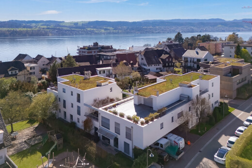 view of building exterior with a water view and a residential view