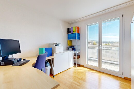 büro mit bürobereich, natürliches licht, natural light, fernseher, und holzfußboden