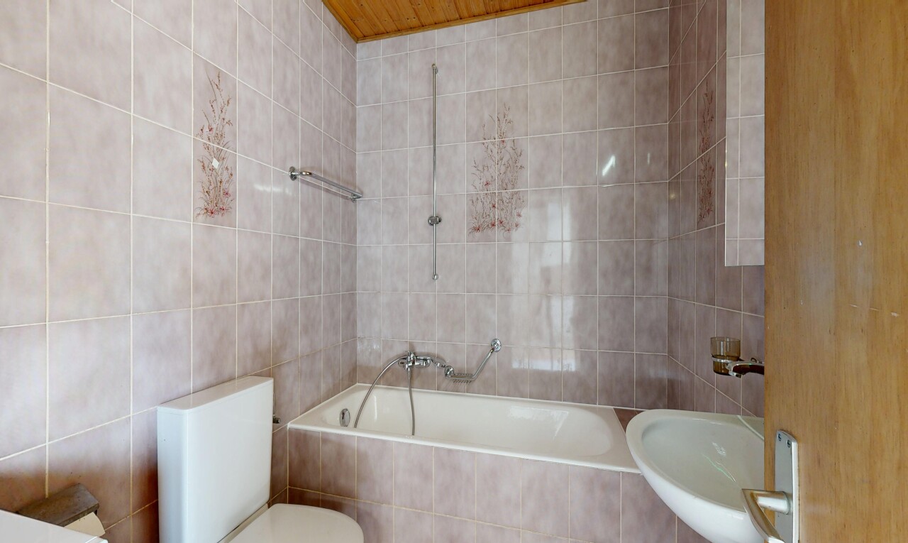 salle de bains avec tile wall, mur en carrelage, toilette, salle de bain complète, et inside property