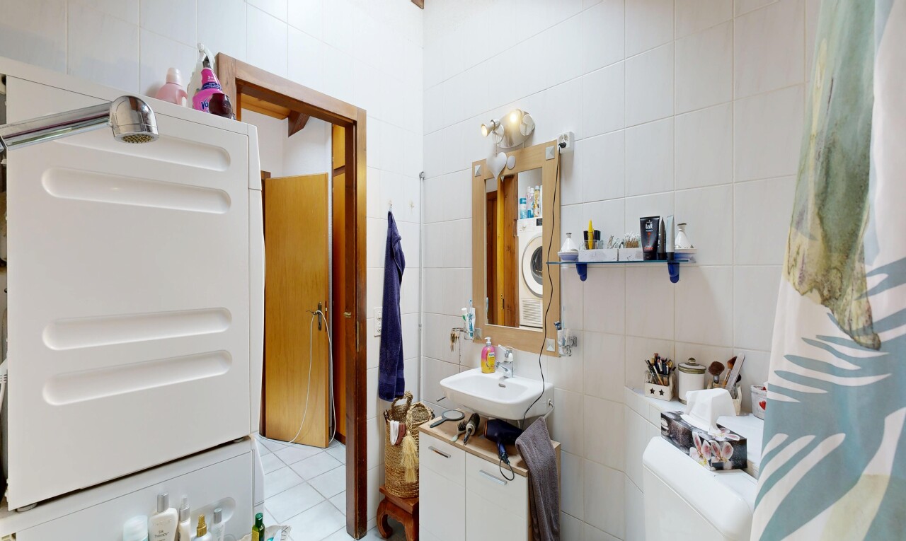 salle de bains avec tile wall, mur en carrelage, miroir, lavabo (ou coiffeuse selon le contexte), et évier