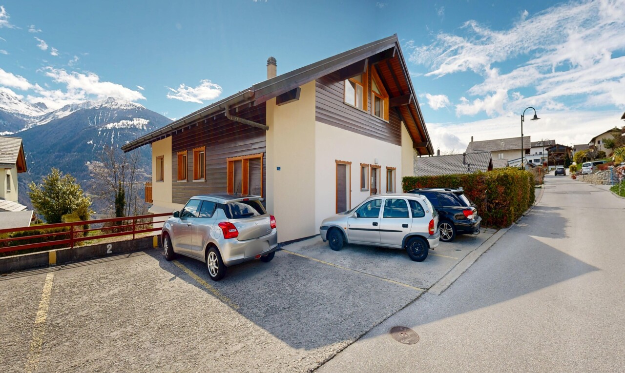 façade avec parking, day time, vue sur la montagne, mountain view, et property visible
