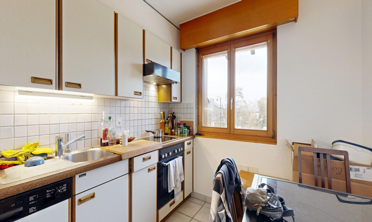 cuisine avec armoires blanches, white cabinets, plans de travail, light countertops, et natural light