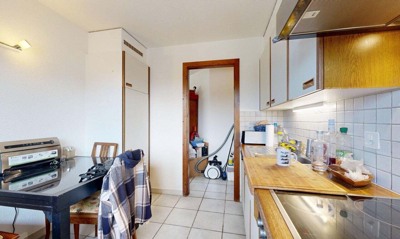 cuisine avec drywall, cloison sèche, hotte, light floor, et armoires blanches