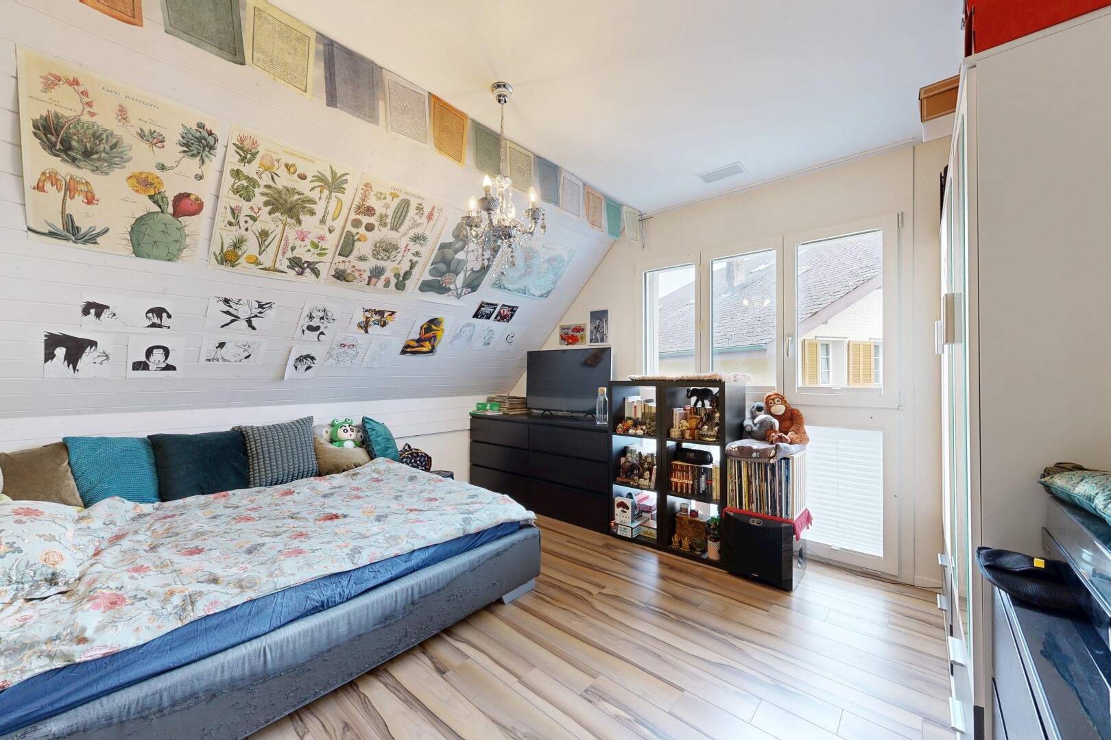 zimmer / schlafzimmer mit inside property, fernseher, holzfußboden, wood finish floor, und bemerkenswerter kronleuchter