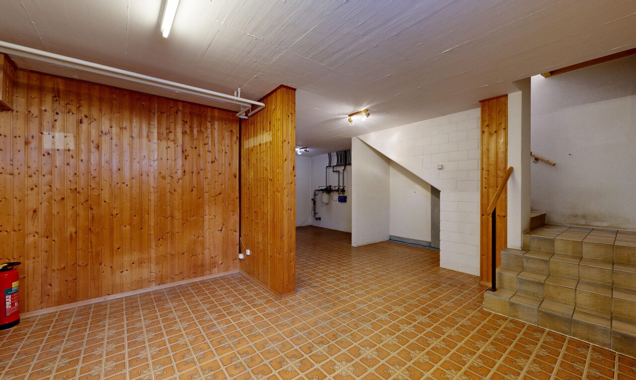 pièce vide avec sous-sol, escaliers, mur en bois, wood wall, et inside property
