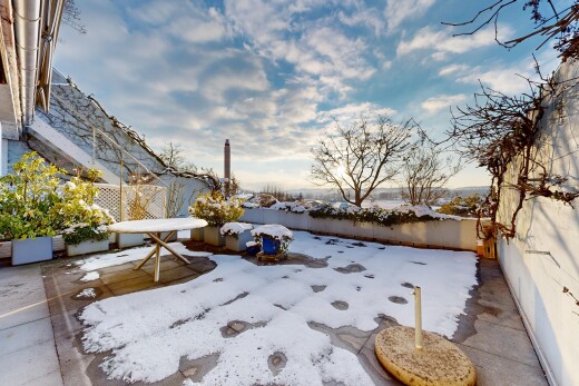 snow covered terrace featuring a patio area