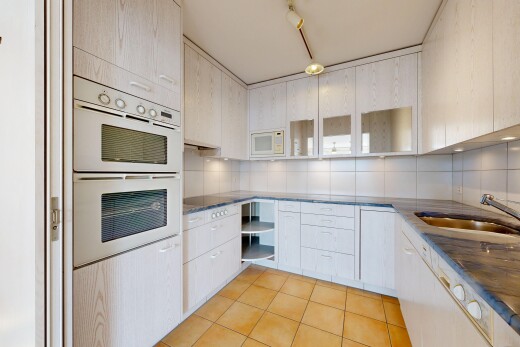 kitchen featuring white appliances, open shelves, light tile patterned floors, and dark stone countertops