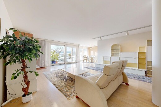 living room with rail lighting and light wood-style floors