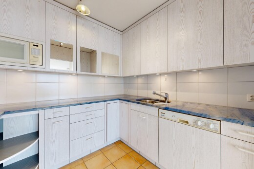 kitchen featuring dishwashing machine, tasteful backsplash, white microwave, light tile patterned floors, and dark stone counters