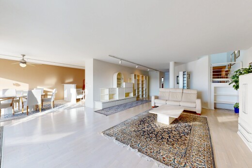 living room featuring rail lighting, light wood-style flooring, and ceiling fan