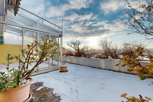 snow covered terrace with a sunroom
