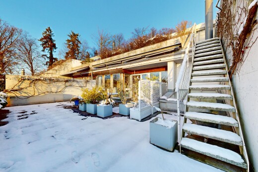 snow covered terrace with a patio area