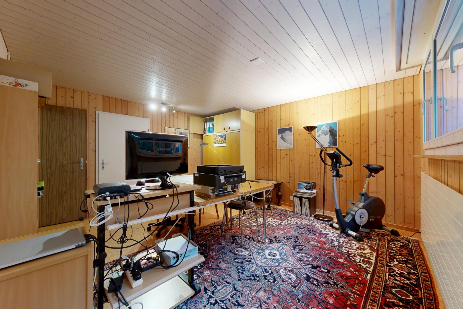 office space with wood walls and rail lighting