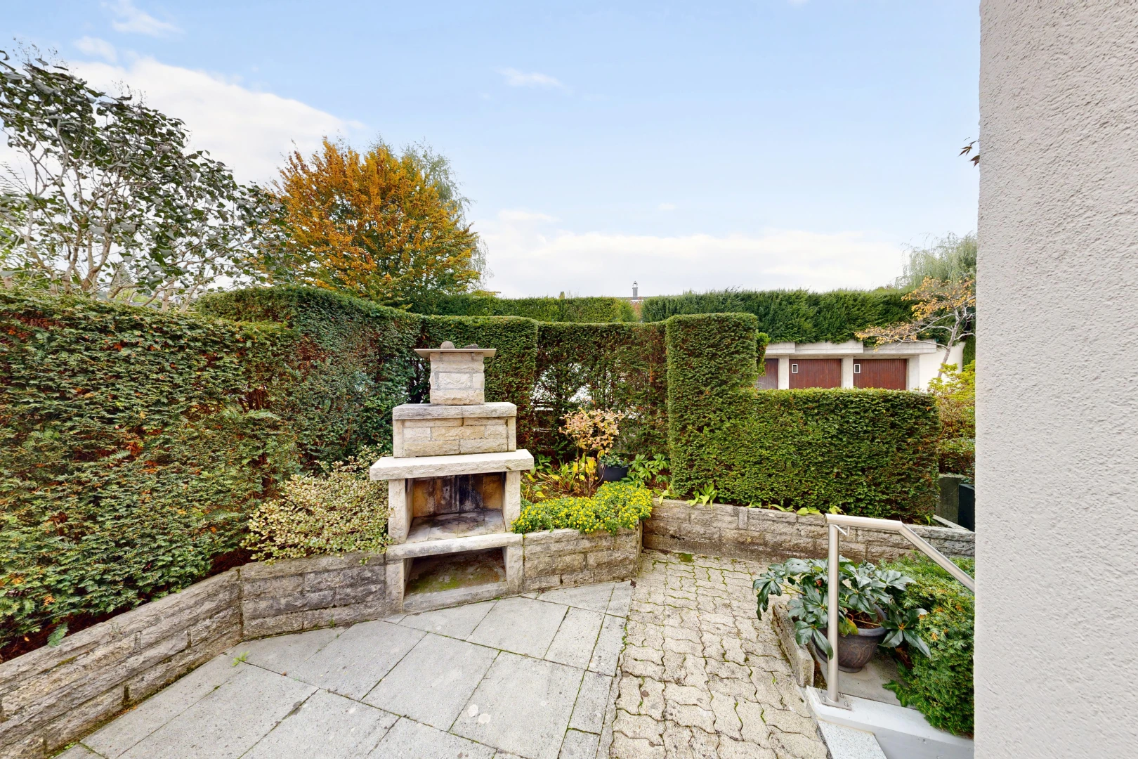 patio / terrace with a patio and an outdoor stone fireplace