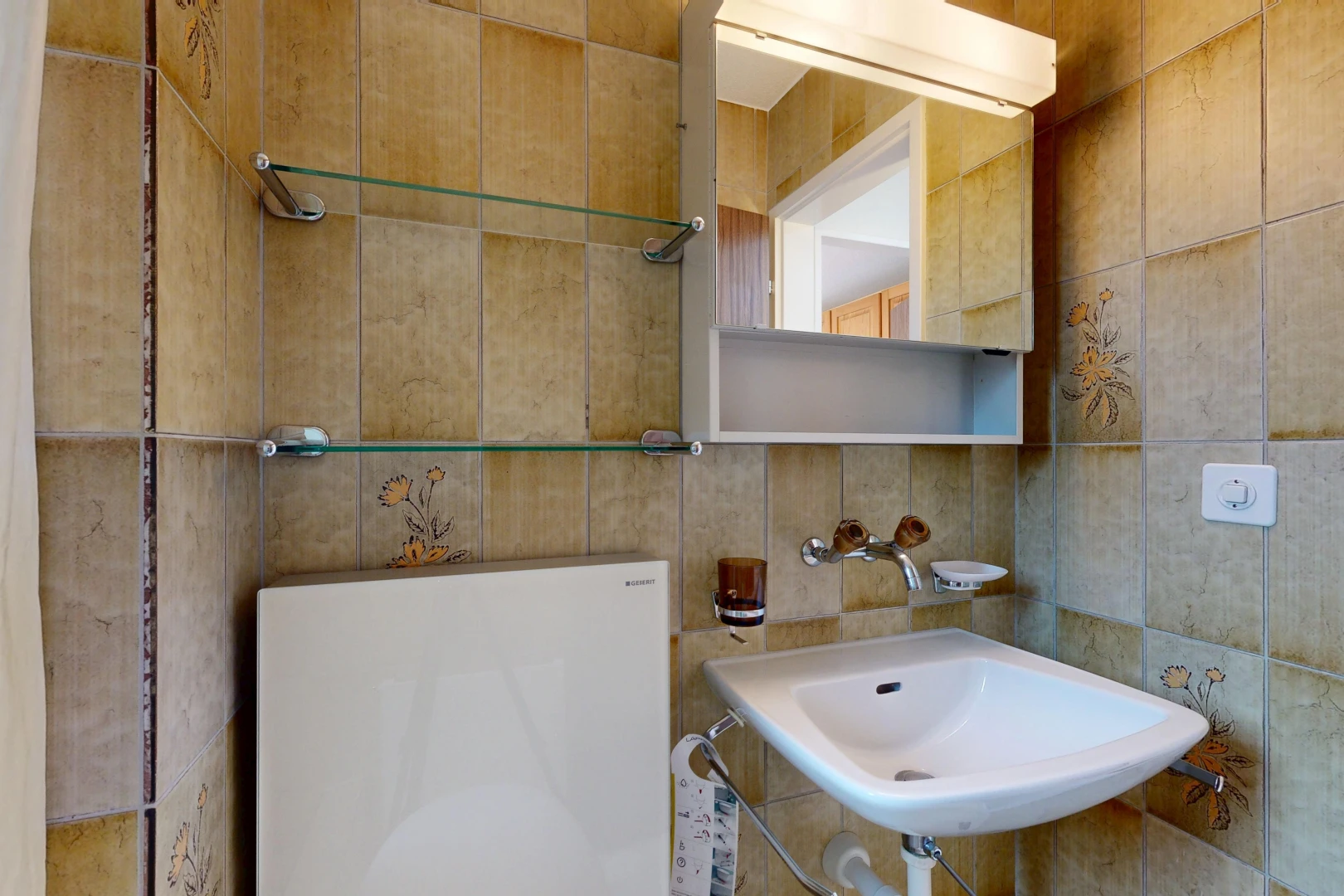 half bath featuring tile walls and a sink
