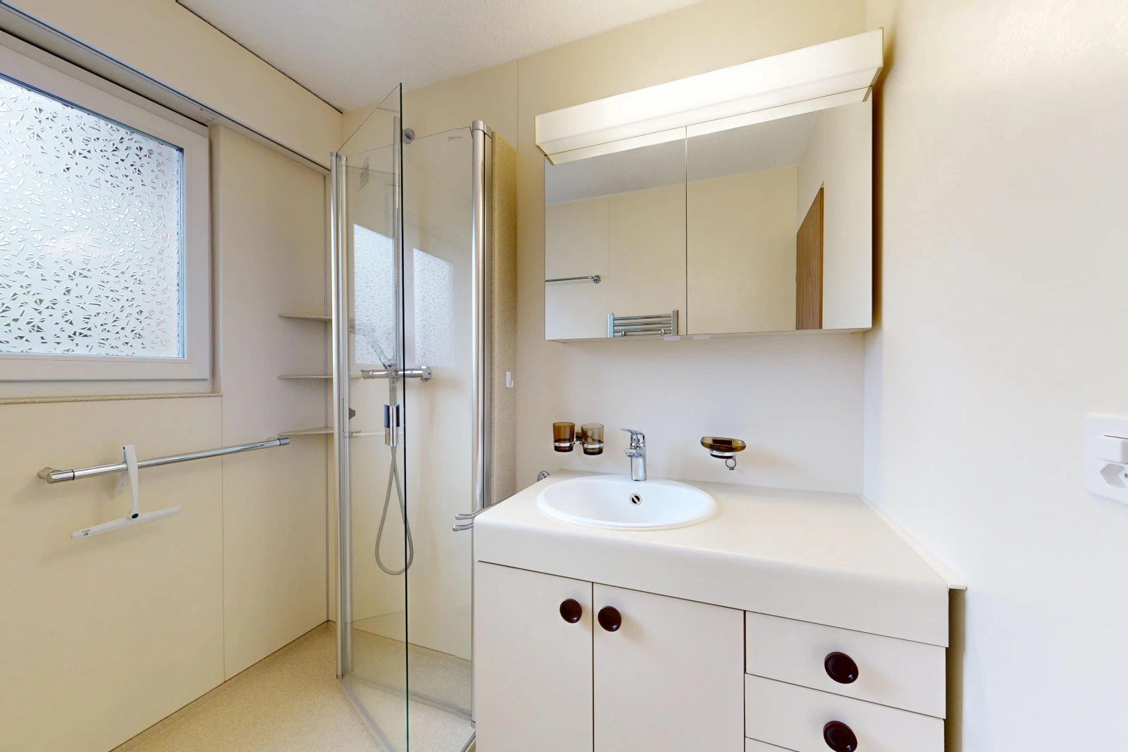 bathroom featuring a shower stall and vanity