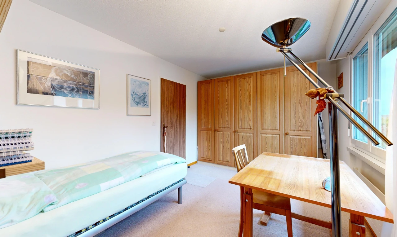 room / bedroom with a closet and light colored carpet