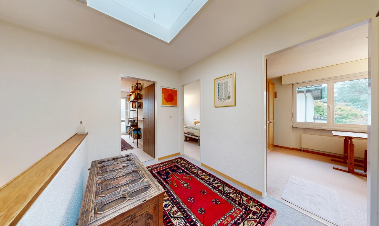hall featuring light carpet