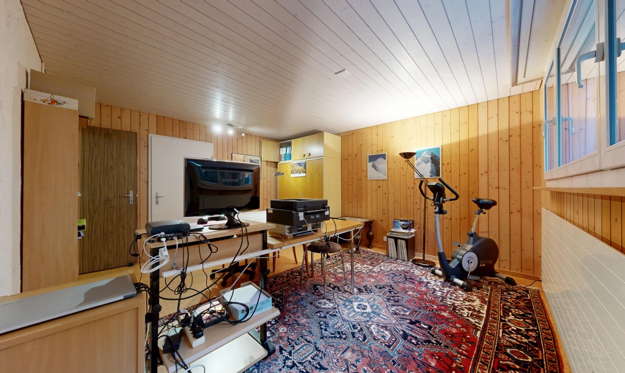 office space with wood walls and rail lighting