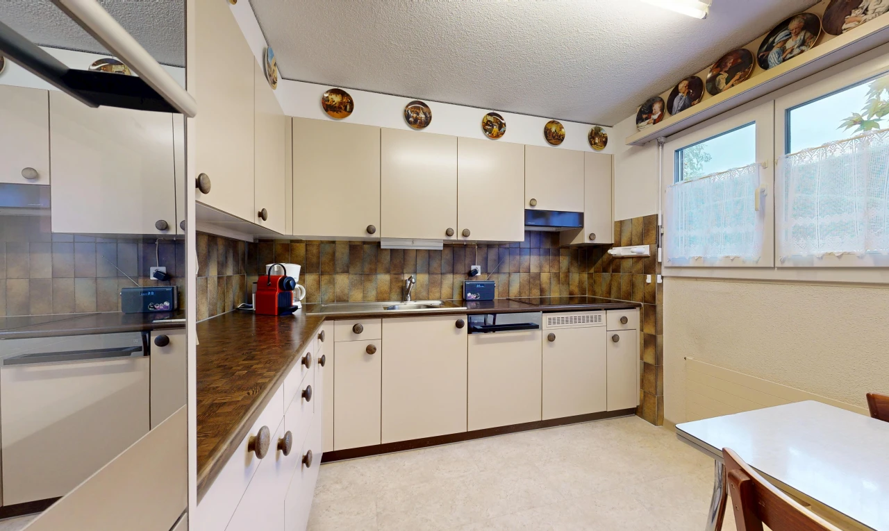 kitchen with dark countertops, exhaust hood, a textured ceiling, and backsplash