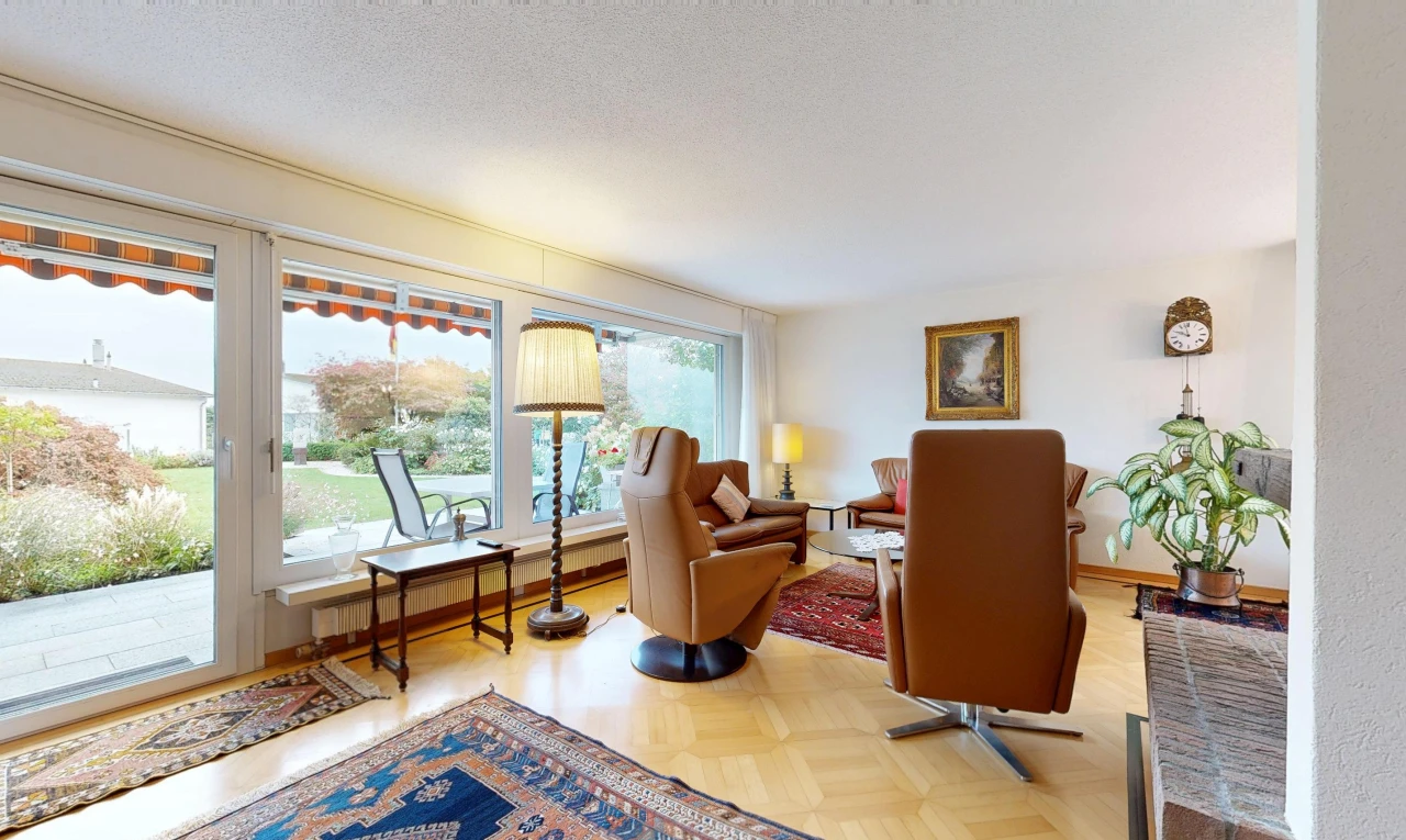 living room featuring access to exterior, parquet floors, baseboard heating, and a textured ceiling