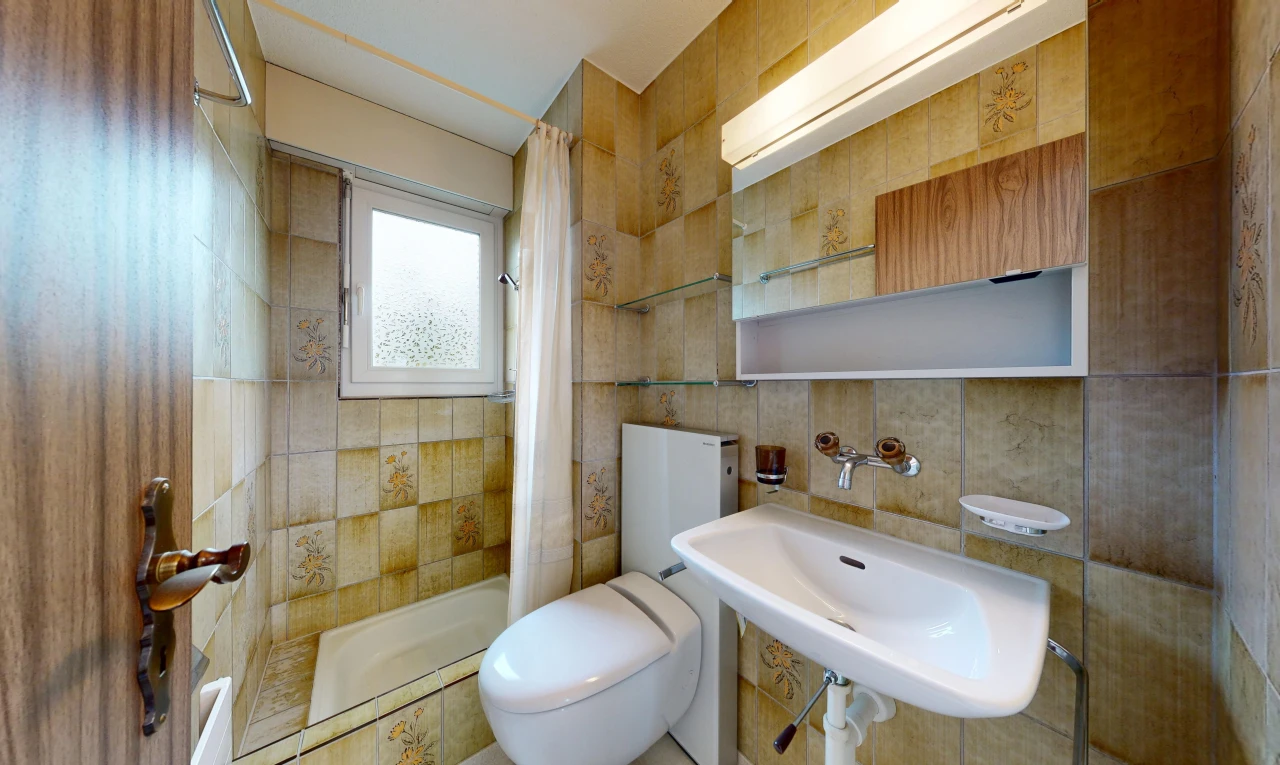 full bathroom with toilet and tile walls