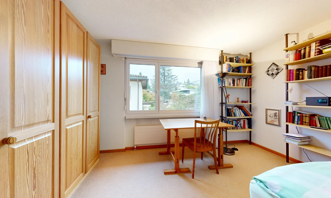 room / bedroom with a closet and light carpet