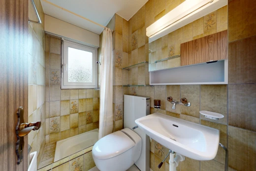 full bathroom with toilet and tile walls