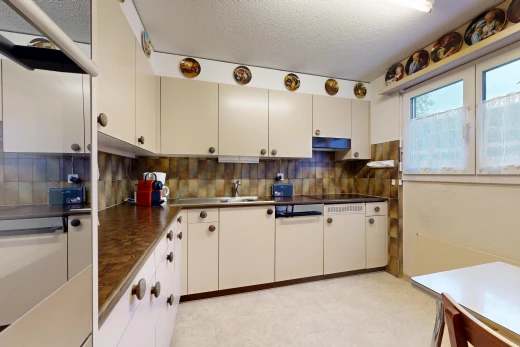 kitchen with dark countertops, exhaust hood, a textured ceiling, and backsplash