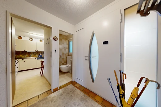 hall with a textured ceiling