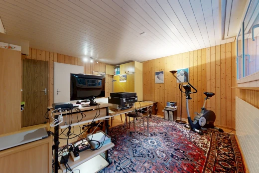 office space with wood walls and rail lighting