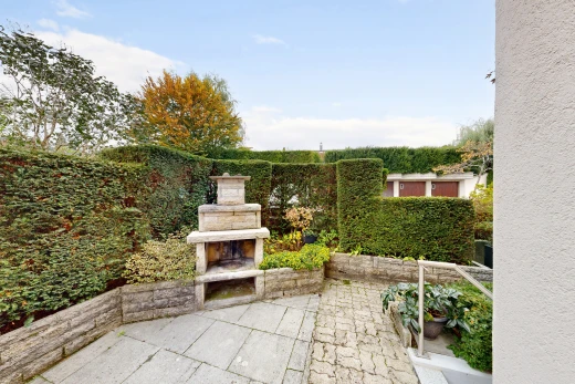 patio / terrace with a patio and an outdoor stone fireplace