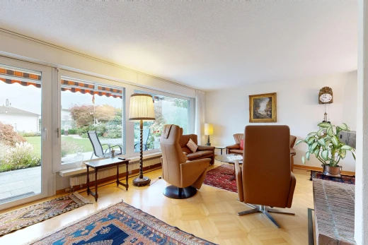 living room featuring access to exterior, parquet floors, baseboard heating, and a textured ceiling