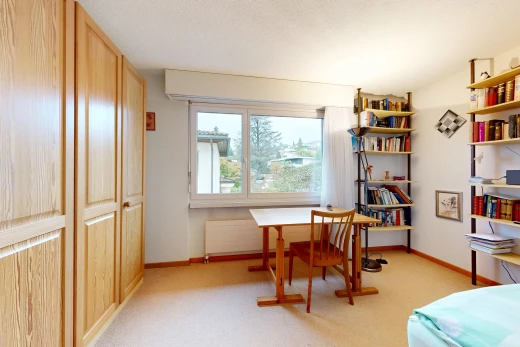room / bedroom with a closet and light carpet