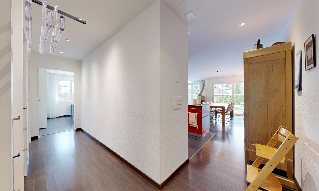 couloir avec sol en finition bois, wood finish floor, inside property, lumière naturelle, et natural light