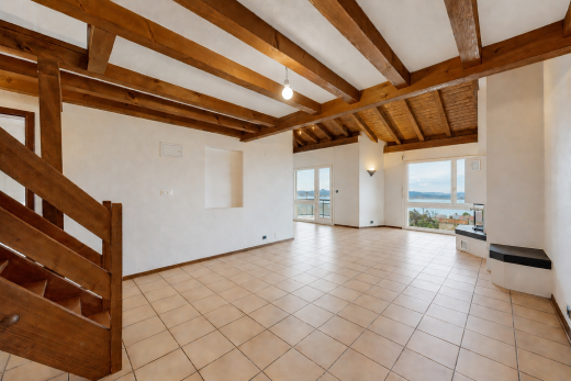 spare room featuring vaulted ceiling with beams and a water view