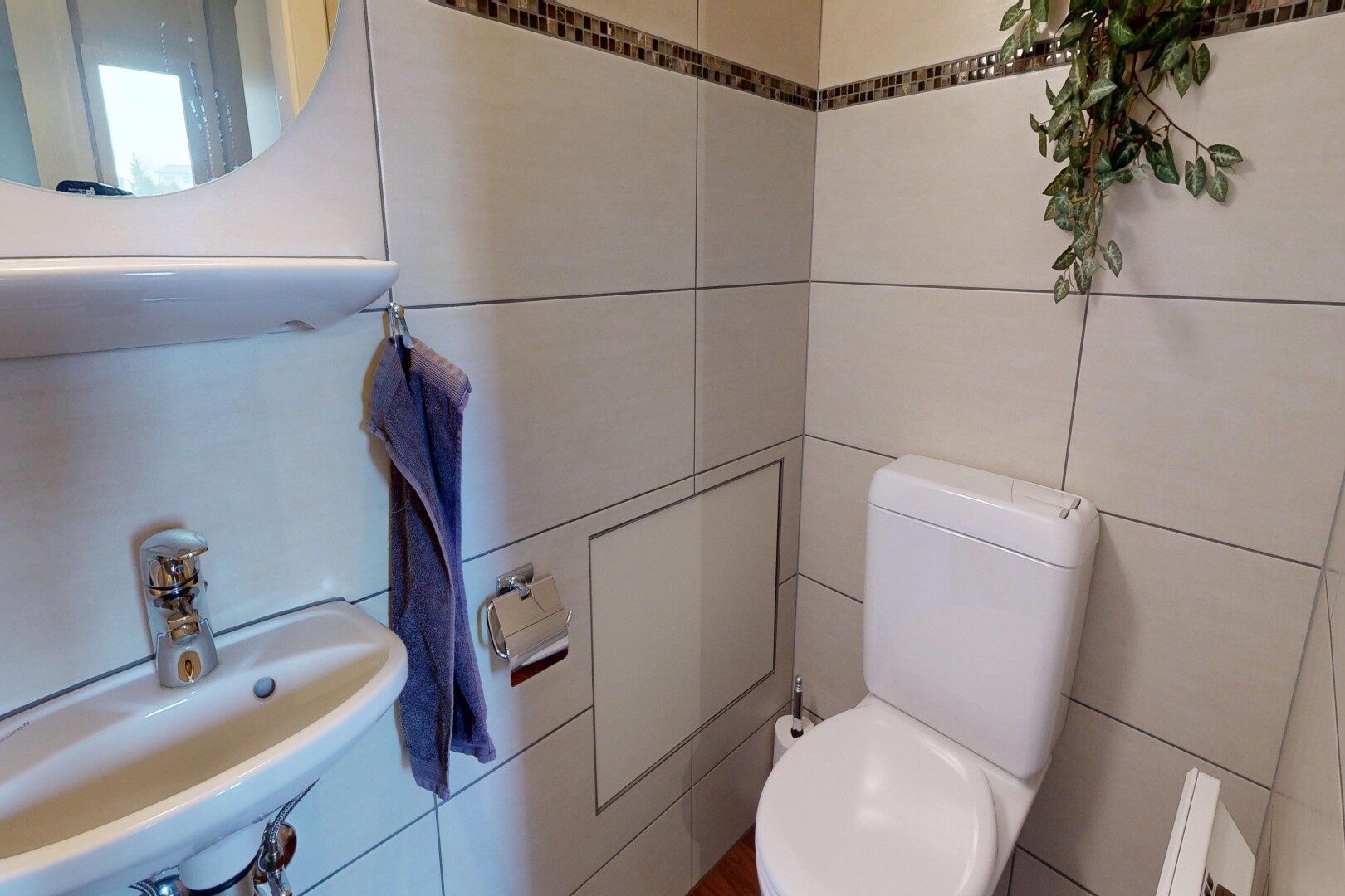 half bathroom with toilet and tile walls
