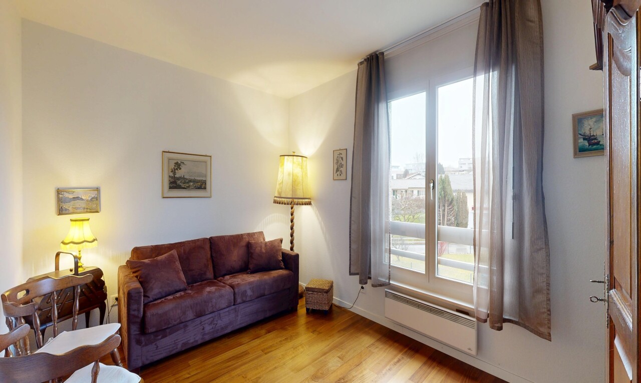 living room with light wood finished floors and radiator heating unit