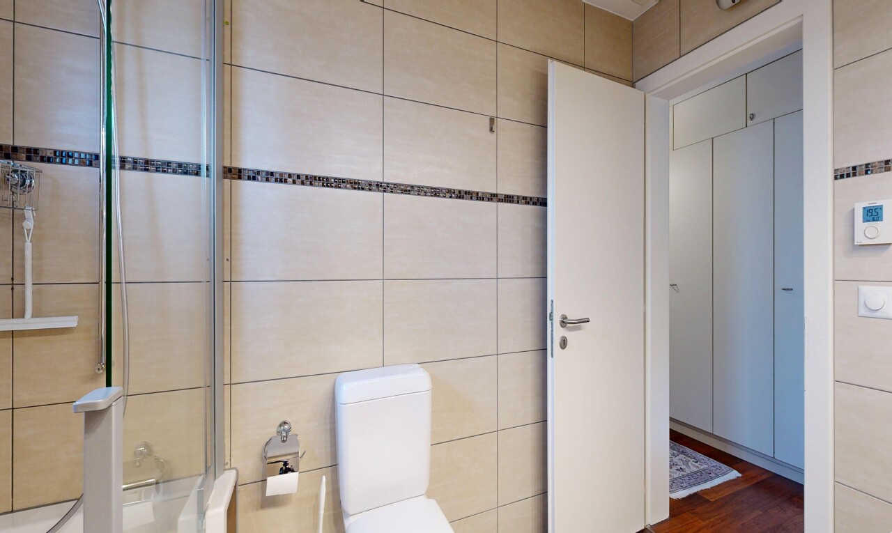 full bathroom featuring toilet and dark wood-style floors