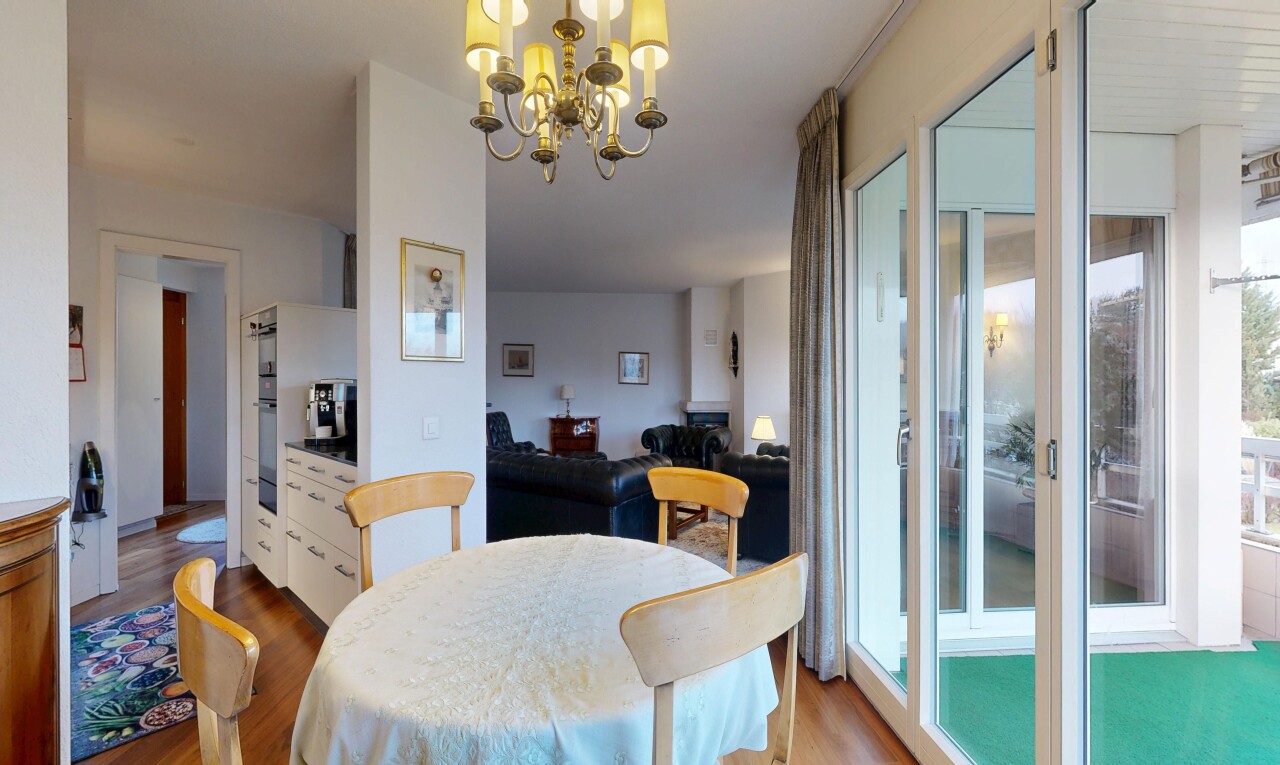 dining space with wood finished floors and hanging lights