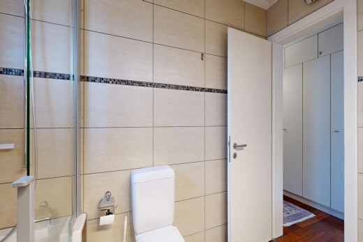 full bathroom featuring toilet and dark wood-style floors